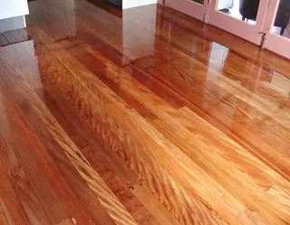 After: Freshly finished hardwood floor with a warm, high-gloss lacquer