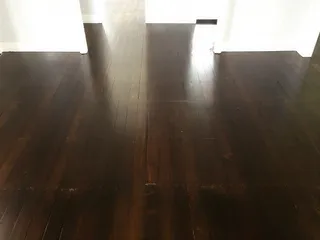 After: Dark espresso-stained hardwood floor after professional sanding and polishing