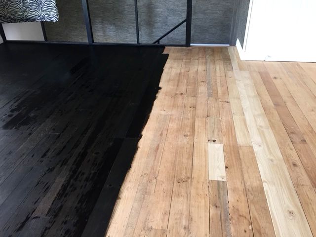 Timber floor mid-restoration, dark stripped section beside newly sanded bare timber treated with Loba Invisible finish