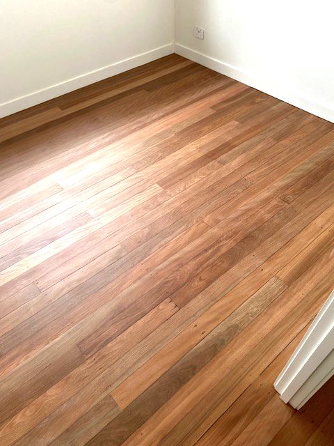 Whitewashed timber flooring running down a hallway