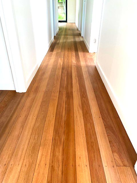 Whitewashed timber floor finished up to the skirting boards